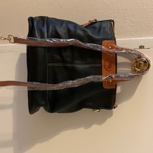 Black and brown Dooney & Bourke bag straps are still in plastic like new